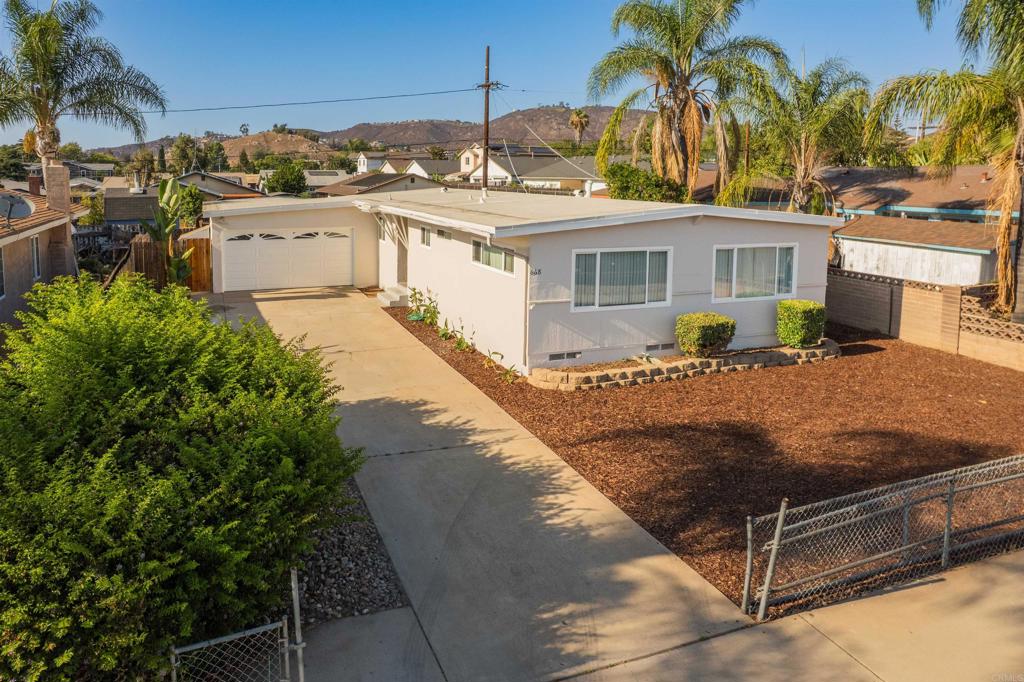 Welcome to this inviting 4-bedroom, 2-bath home located in the heart of El Cajon. Nestled in a quiet neighborhood, this 1,378 sq ft property offers a smart, functional layout with fresh paint and new laminate flooring throughout the main living areas. The spacious kitchen provides ample cabinet storage—perfect for all your cooking needs. All four bedrooms feature brand-new carpet, offering flexible space for family, guests, a home office, or extra storage. Step outside to a large, fully fenced front and backyard—ideal for kids, pets, or entertaining. The backyard boasts a built-in BBQ area, covered patio, and room for gardening, creating your own private outdoor retreat. A two-car garage adds secure parking and additional storage. Conveniently located just minutes from freeways, shopping, restaurants, and public transit, this home is perfect for first-time buyers, families, or investors seeking long-term value.