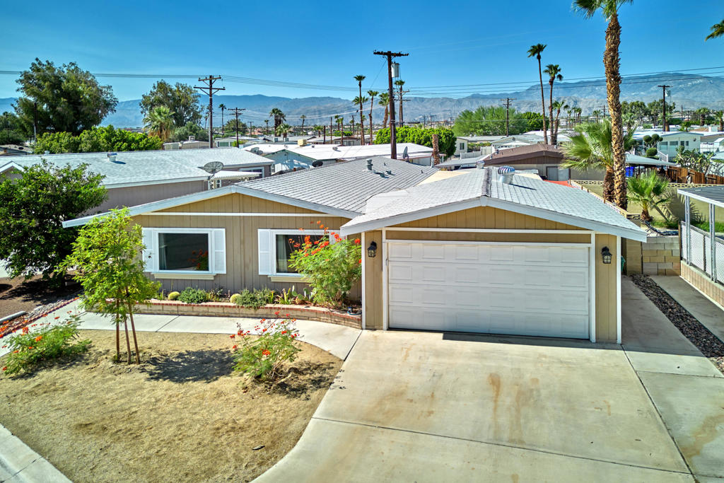 Looking for a great spot in the desert? Check out this freshly remodeled, move-in-ready home in Tri Palm Estates & Country Club--an active 55+ community where you actually own the land! This 2-bedroom, 2-bath home sits on a PERMANENT FOUNDATION WITH 433A CERTIFICATION, which means financing is a breeze.Step inside and you'll find an open, airy floorplan with stylish luxury vinyl plank floors, fresh paint, and new trim throughout. The kitchen is newly updated--cabinetry, quartz counters, shiny appliances, and modern fixtures--so you're all set for cooking and entertaining. There's also a private covered patio for relaxing outside, plus a powered workshop for projects or extra storage.Living here means unlimited free golf on both an 18-hole course and a 9-hole par-3, a putting green, swimming pools, spas, tennis, pickleball, shuffleboard, basketball, and a clubhouse loaded with a banquet room, bar, restaurant, billiards, and lots of clubs and activities.You're super close to all your essentials--Costco, Sam's Club, Home Depot, Lowe's, Walmart--and fun spots like Agua Caliente Casino, Eisenhower medical campus, and Acrisure Arena for hockey and concerts. With quick access to I-10, it's just minutes to Palm Desert, Rancho Mirage, and downtown Palm Springs.This is the perfect place for anyone wanting a fun, easygoing desert lifestyle!
