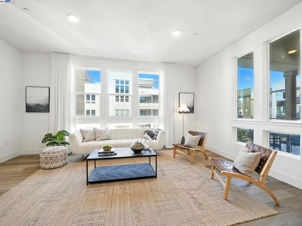Welcome to this stunning condo at Metro Crossing! Built in 2022, this luxurious 3-bedroom, 2.5-bath condo offers 1,887 sq. ft. of single-level living. With elevator access and only six units in the building, privacy is unmatched. A private 2-car side-by-side garage with extra storage adds convenience. The open floor plan features high ceilings, stacking sliding patio doors, and an oversized covered balcony with a gas fireplace and incredible views. The chef’s kitchen boasts a large island with pendant lighting, quartz countertops, a tiled backsplash, stainless steel appliances, a pantry, and abundant cabinetry with under-cabinet lighting. The spacious primary suite includes high ceilings, a walk-in closet, dual sinks, a soaking tub, and a glass-enclosed shower. Other highlights: an office space, laundry room with washer/dryer and cabinets, and well-sized bedrooms with closets. Enjoy resort-style amenities—clubhouse with Wi-Fi, indoor/outdoor event space, fire tables, fitness center, and a junior lap pool. Located across from Warm Springs BART and near I-680/880. HOA dues: $568 Russel Square + $150 Metro Crossing monthly.