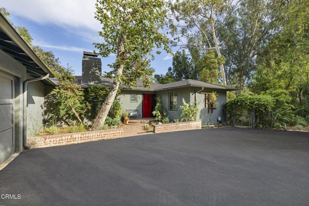 Tucked away at the end of a verdant, tree-lined street, this 1938 Traditional-style home retains many of its original architectural details, including crown moldings, gleaming hardwood floors, and built-in bookcases.The elegant living room features floor-to-ceiling windows that open to a cozy sunroom and offer views of a charming brick patio beyond. A lovely dining alcove sits just off the galley-style kitchen, which boasts rich mahogany countertops and a vintage stove, blending character with functionality.Two generously sized bedrooms flank an updated hall bathroom adorned with custom tile work. Light fills the home through numerous windows, including a stunning bay window with floor-to-ceiling panes that invites the outdoors in.Set on an expansive 20,860 sq ft lot, the property offers a rare opportunity for future expansion or landscape design, with several areas yet to be developed. Surrounded by larger estate homes, this gem is ideally located near the Rose Bowl, Brookside Golf Course, the Pasadena Aquatic Center, and just minutes from the shops and restaurants of Old Pasadena.