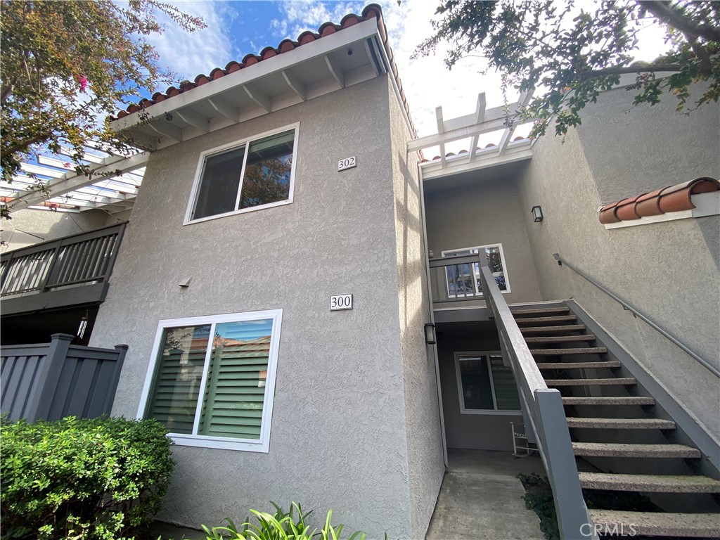 Beautifully upgraded 2-bedroom, 2-bath upper-level condo in Orangetree community of Irvine. This bright and modern home offers rare privacy with its own private entrance—no shared stairs with neighbors. High vaulted ceilings, recessed lighting, and expansive windows create a light-filled, inviting atmosphere. The spacious living area opens to an oversized balcony with peaceful tree views, perfect for relaxing or entertaining. The kitchen features quartz countertops, stainless steel appliances, and a sleek waterfall island. Both bedrooms include generous closet space, with durable laminate flooring throughout and plush carpet in the primary suite. Bathrooms are tastefully updated with quartz vanities and contemporary fixtures. A dedicated laundry area accommodates a side-by-side washer and dryer. The property includes a one-car assigned covered carport along with ample guest parking. Residents enjoy access to community amenities including pools, spa, tennis and basketball courts and a clubhouse. Ideally located near the Irvine Spectrum, Great Park, and Marketplace, with easy access to Oak Creek Community Park, shopping, dining, and freeways!