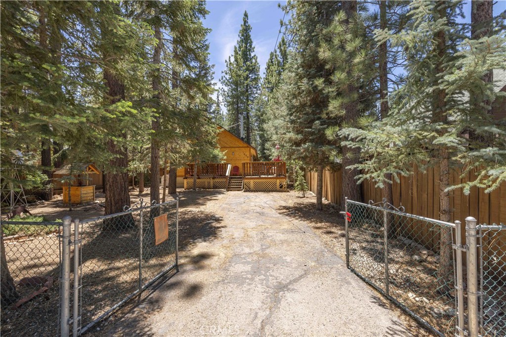 Remodeled Mountain Getaway with Treehouse Vibes! Tucked in a prime Big Bear location, this beautifully updated retreat blends mountain charm with modern comfort. The remodeled kitchen opens to a spacious and airy floor plan, creating a seamless flow that's perfect for relaxing or entertaining. Both generously sized bedrooms are located on the main level, making single-story living a breeze. Step onto the expansive wraparound deck that feels like it floats in the treetops—ideal for morning coffee or evening gatherings with friends. This home is a serene escape with inspiring design touches throughout.
