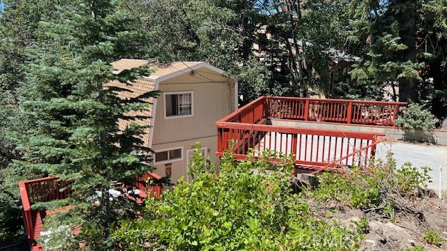Price Reduction! Gambrel Style cabin offers 3 bedrooms and 2 baths on 3 floors, 1 bath on main floor with kitchen, dinning room, wood burning stove with sitting area with its own private deck. Downstairs offers a family and 1 more bath and a wood burning stove with a sleeping area and access to back yard. This cabin offers a slice of paradise amidst breathtaking surroundings and located on the quite side of the valley, cabin is a dream come true for outdoor enthusiasts and nature lovers alike, for those who crave winter adventures, this idyllic town is also in close proximity to Snow Valley Ski Resort making it a perfect haven for snow boarders and skiers. the floor plan I s versatile it either had 3 bedroom or 2 bedrooms and a den/ game room with a bathroom on 2 levels. Curb appeal with mature pine and fir trees, the setting is private with 2 entertaining decks for those warm summer nights in Green Valley Lake, parking structure is made with block and cement to last a lifetime.