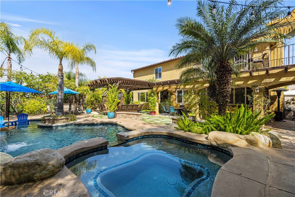 SPECIAL FINANCING FOR THIS HOME FIXED RATE FOR 10 YEARS AT JUST 5.5% (5.542 APR) RV PARKING & OWNED SOLAR!!! Welcome to Your Dream Home in the Exclusive Gated, Enclave Community at Stevenson Ranch! This beautifully upgraded five-bedroom, three-bath residence is nestled within one of the most desirable gated communities in the valley—offering a perfect blend of luxury, comfort, and functionality. This is an entertainers dream home! From the moment you step inside, you're greeted by soaring high ceilings, a custom-built stairwell, and a spacious, open layout. The gourmet kitchen is a chef’s delight featuring top-of-the-line finishes and modern upgrades throughout. Unique highlights include a custom game room and a charming, built-in wine room cleverly tucked beneath the staircase—ideal for stylish entertaining. Step outside to your private backyard retreat, where California living shines. Enjoy a recently refinished pool with gorgeous new tiles, tranquil water features, and an upgraded fire pit surrounded by beautiful stonework. The covered patio with a built-in fireplace creates the ultimate outdoor living space for gatherings or quiet evenings at home. Energy efficiency meets innovation with fully paid-off SunPower solar panels, providing coverage for up to 90% of your electric bill—delivering sustainability without sacrificing luxury. The property also includes RV parking with an electric gate and access to all the upscale amenities that make Stevenson Ranch such a coveted location. Ideally located near shopping, dining, entertainment, and offering easy access to major freeways—this home truly has it all. Don’t miss the opportunity to own this exceptional Stevenson Ranch masterpiece—where elegance meets everyday living.