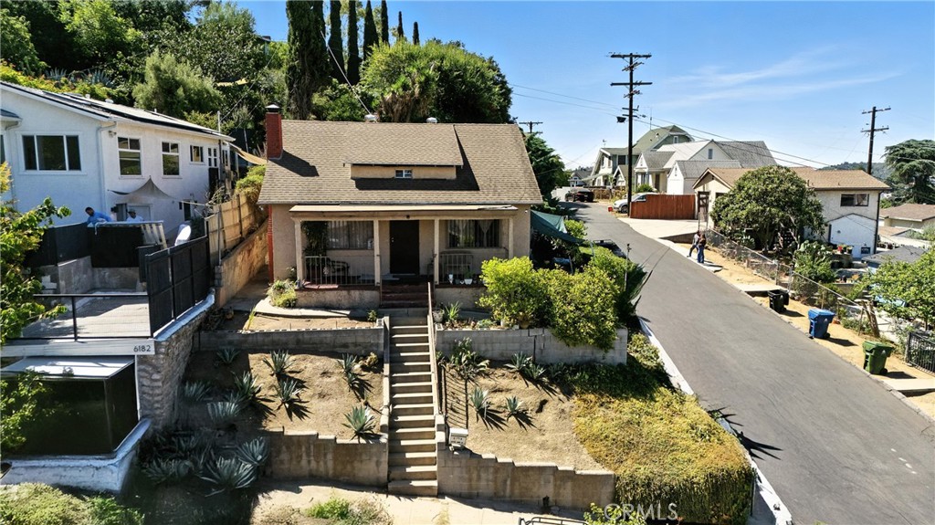 Highland Park Residence features 2 bedrooms, a loft and 1.5 bathrooms, complemented by a detached 2-Car Garage that includes a Studio/Guest House above approximately 450 sq ft. of living space complete with a full kitchen, bathroom and closet and a Pool with Epic Views at properties top tier! Situated on a gentle upslope in the desirable Garvanza area of Highland Park , this property boast Panoramic Views through out ,approximately 1,130 sq ft of living space at main house , a newer roof , a wood burning fireplace and a large kitchen that opens up to the formal dining area making it a perfect canvass for the buyer looking to break into this Higly sought after neighborhood with the potential to collect income from the back house or an Investor looking for a high rate of return. Property will be delivered Vacant and is located minutes away from bustling York blvd and Figueroa st. corridors with quick access to the metro gold line ,110 and 5 freeways making the commute to Downtown La and Pasadena a breeze. Nearby Parks and hiking trails offer nature lovers a perfect balance of city living and outdoor space.