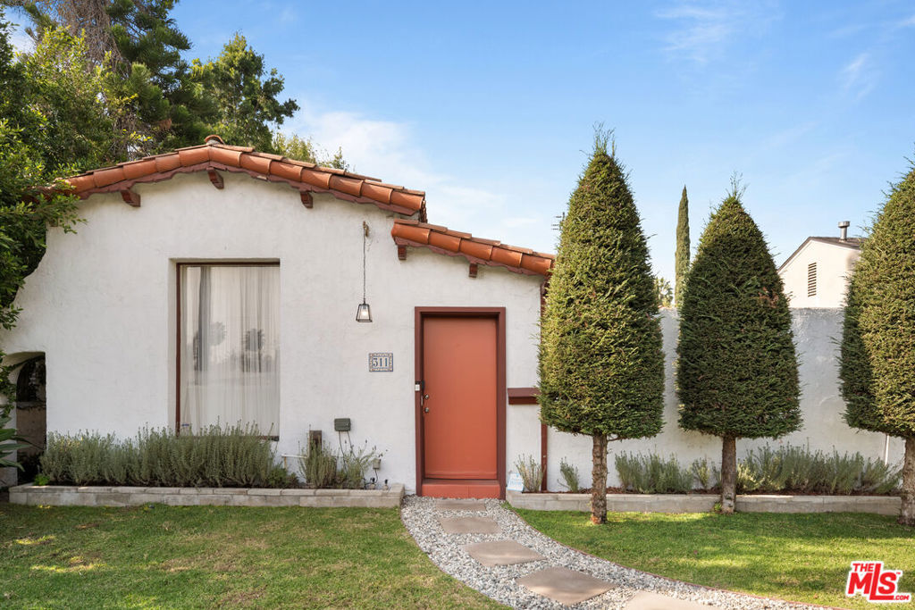 Located in Beverly Hills, this renovated single-story home offers privacy and convenience. Enclosed by tall hedges and a gated entry, the property features a driveway with space for up to five stacked cars and a secure front patio, perfect for relaxing or entertaining. Inside, the home includes a large living room with hardwood floors, a formal dining area, and a kitchen with a center island and natural light from oversized windows equipped with remote-controlled blinds. The primary suite has two walk-in closets and a bathroom with a soaking tub and separate shower. Two additional bedrooms have sliding door access to the backyard, which offers space for entertaining or gardening. This home is part of the highly-rated Beverly Hills Unified School District and is conveniently located near shopping, dining, and local amenities.
