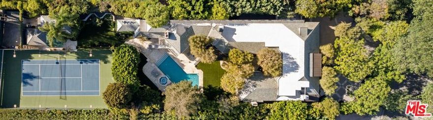 Stunning tennis court estate set in the highly sought-after Beverly Hills Flats. This approx 13,600 SF estate sits on almost an acre lot and is behind a gated motor court and lush greenery to provide the utmost privacy. Enter to a grand foyer with soaring ceilings and beautiful finishes throughout. The double height formal living room has floor-to-ceiling windows that allow natural light to fill the home. Kitchen offers high-end appliances, oversized island, and breakfast area. Spacious primary suite offers fireplace, private balcony, dual bathrooms, walk-in closet, and wet bar area. 7 additional ensuite bedrooms provide ample space. Resort-like grounds offer large pool, spa with waterfall, built-in BBQ, large flat lawn, expansive patio, and night-lit tennis court. A detached guest house sits next to the tennis court and is the perfect place to relax after a match. Make this incredible estate your home and live moments from the best dining and shopping that Beverly Hills has to offer. Viewings by appointment only. Call agents for a private showing.