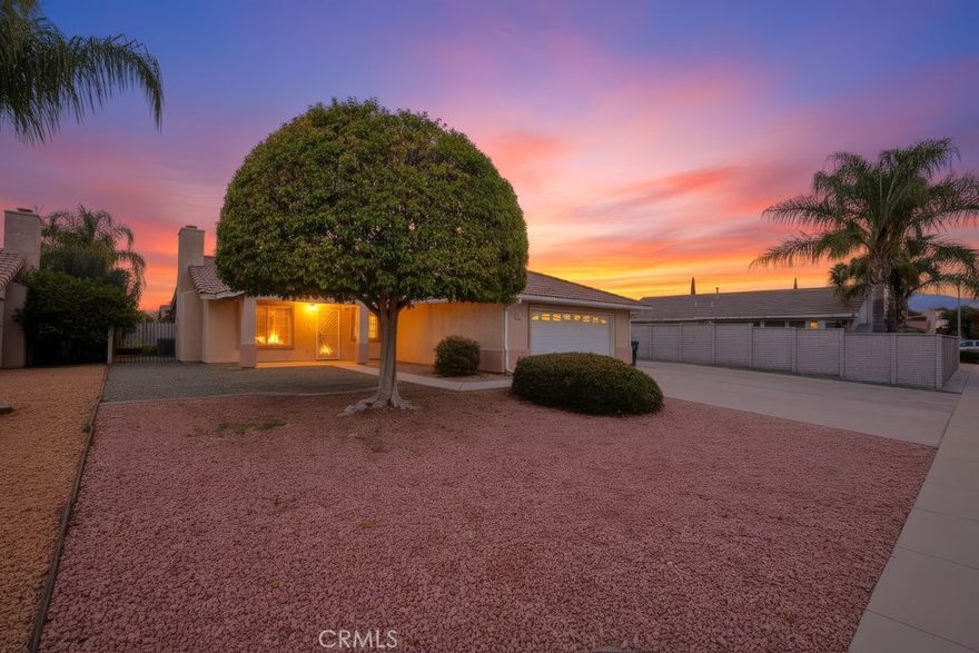 This beautifully maintained 3-bedroom, 2-bathroom home sits on a large 10,000 square foot lot in the Desirable 55+ Community of Crean Acres. The living room features high ceilings, laminate wood flooring, fireplace and plenty of natural light that flows through the dining area and into the kitchen. The kitchen includes granite countertops, lots of cabinet space, Stove, fridge and dishwasher.  The large primary bedroom boast sliding doors to the back patio, two large closets, ceiling fan and a full primary bath. The other two bedrooms are good size, both with ceiling fans and soft carpets.  One bedroom includes a full length desk and work area making it the perfect spot for an office. The guest bathroom features a convenient walk-in shower with cool flexible shower head. The front yard is easy care landscape in front of the house and a full concrete slab that stretches from the garage to the gated RV parking on the side. The garage is an oversized two car with an abundance of cabinet space, washer/dryer hook-up (Washer/Dryer included!), work station plus room for two cars. In back you find an expanding yard of fake grass (no mowing) fruit trees, tuff shed and patio to sit and enjoy it all. All this is located in a well-kept 55+ residents community with low annual dues of just $60, that is  close to shopping, dining, and local amenities.