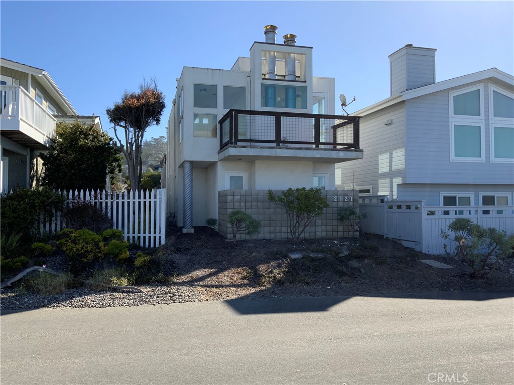 This Marine Terrace fixer sits in a desirable street-to-street location stretching from oceanfront Windsor Boulevard to Sherwood. The property includes a detached two-car garage with a rooftop deck that connects to the second level of the main house. Designed in a contemporary style, the home features tall ceilings, abundant windows, and two fireplaces—one in the living room and another in the main bedroom. While the house is in need of a full down-to-the-studs remodel, it offers the opportunity to create a stunning beach-side retreat. The layout includes two bedrooms and a main bathroom on the first floor, along with a guest half bath upstairs. A spacious deck on the ocean side of the house provides the perfect spot to take in sunsets over the Pacific. This is your chance to bring your vision and your contractor to transform it into a beautiful coastal getaway.