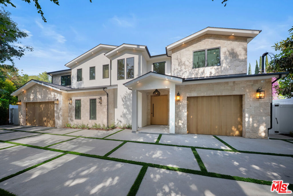 Timeless Luxury in Prime Encino | 6,300+ Sq Ft Gated Estate on Expansive 14,300+ Sq Ft Lot. Experience elevated California living in this stunning gated residence nestled on a private flag lot in the heart of Encino. Spanning over 6,300 square feet, this 5-bedroom, 5.5-bathroom home showcases timeless elegance with ultimate privacy and sophisticated design throughout. Step into a grand entryway featuring a dramatic pivot door, soaring ceilings, and an entertainer's bar that sets the tone for the home's luxurious ambiance. Beautiful fixtures and custom finishes are showcased throughout the residence, including solid white oak wood doors, fluted Venetian plaster walls, and rich wood trim detail crafted by experienced builders. The glamorous chef's kitchen is a true showpiece, outfitted with high-end custom inset cabinetry, premium Thermador appliances, and thoughtful design for both function and style. The generous primary suite provides a serene retreat, featuring dual walk-in closets (one for him and one for her) and a spa-inspired bathroom. Additional interior highlights include a private office, home theater, gym, and a spacious loft. Smart home features abound with full Control 4 automation, integrated security, solar panels, and EV car chargers. A 3-car garage adds convenience and space. Outside, the entertainer's backyard is a resort-style oasis complete with a sparkling pool and spa, outdoor fireplace and grill, basketball court, and multiple lounge areas for year-round enjoyment. Located in the highly sought-after Encino Flats within the coveted Hesby Oaks School District, this truly unique property offers a rare blend of elegance, comfort, and exceptional craftsmanship.