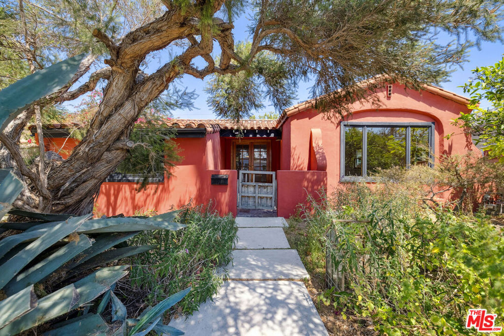 Welcome to this special Spanish home, situated behind a wild, whimsical front yard filled with California native plants, fruit trees, and cacti. This soulful Spanish-style gem features an original pink-tiled kitchen with a classic O'Keefe & Merritt stove, adding timeless character and vintage appeal. At the heart of the home, the dining room with charming built-ins and cozy nooks sits between the living room and kitchen, creating an easy flow for entertaining and everyday living. French doors lead to the front patio, perfect for enjoying your morning coffee. The bright living room is filled with natural light, showcasing a beautifully barreled ceiling and a picture-perfect window. Throughout the home, three skylights, laundry closet with storage, new refrigerator, a new HVAC, and thoughtful architectural details like the original purple and black full bath enhance the home's special charm. A second set of French doors opens to an enchanting tiled backyard oasis, complete with fruit trees, lush vines, and a dining area under a grape arbor for unforgettable al fresco evenings. Located just a short stroll from the highly regarded Playa del Rey Elementary School and only blocks from the Playa Vista tech hub, this home offers both convenience and community. For nature lovers, nearby hiking trails, parks, and bike paths provide endless opportunities to explore the outdoors.