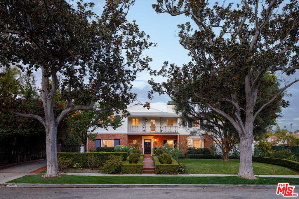 A beautifully updated 1922 original in prime Beverly Hills Flats, this exquisite 5-bedroom home is surrounded by manicured gardens & mature trees. Light, bright interiors showcase detailed crown molding and new modern fixtures, including the formal living and dining rooms and family room with skylights and French doors. The chefs kitchen boasts aquarela stone countertops, custom center island, Sub-Zero fridge/freezer, walk-in pantry and breakfast area, open to the resort-style backyard with privacy hedges, pool/spa, dining terrace, BBQ kitchen & wine cellar. Upstairs, find the stunning primary suite with soaring ceilings, terrace, fireplace, walk-in closet and spa bath. Remodel plans are included from Architect Richard Manion to reimagine the detached guest house and 2nd floor to include 5 bedrooms. Features include a bonus room, carport, exterior cameras & high-tech alarm system. Offering absolute privacy, the home is moments from Rodeo Drive, acclaimed schools, shopping and dining.
