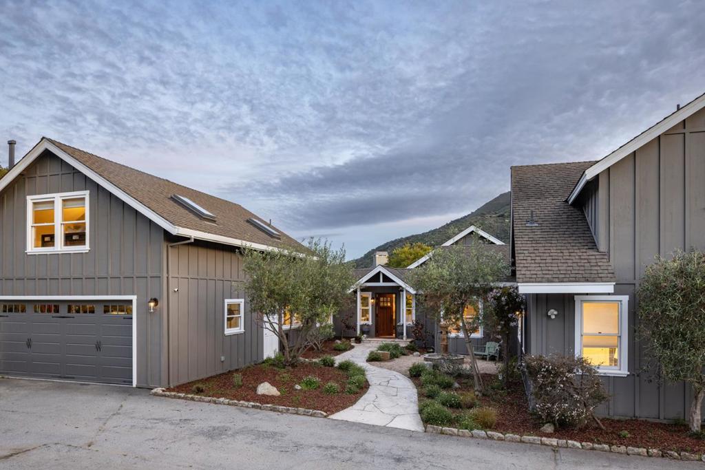 Nestled on a beautifully landscaped acre in the heart of sunny Mid Carmel Valley, this remodeled 3,500 sq. ft. modern farmhouse combines style, luxury, and functionality. Featuring 4 bedrooms, 2.5 baths, and an open, flowing floor plan, this home offers abundant space for both everyday living and entertaining. The home features abundant natural light due to its southern exposure, as well as beautiful mountain views and gorgeous sunsets in the evening. The main level welcomes you with a formal entry, gourmet kitchen, a spacious family room, two bedrooms and more. The grand great room is a showstopper, with hardwood floors, plantation shutters, vaulted and beamed ceilings, and a stunning river rock fireplace. Upstairs, the private primary suite offers a serene retreat, complete with a spa-like bathroom and walk-in closets. The 630 SQ FT 4th bedroom is perfect for multiple uses and has a private deck to take in the breathtaking valley views. Designed for seamless indoor-outdoor living, the property boasts lovely patios, a lush turf lawn, beautiful gardens, a raised vegetable garden, and even a hobby vineyard. With sweeping valley vistas and ample space for entertaining, this home truly offers the perfect Carmel Valley lifestyle!