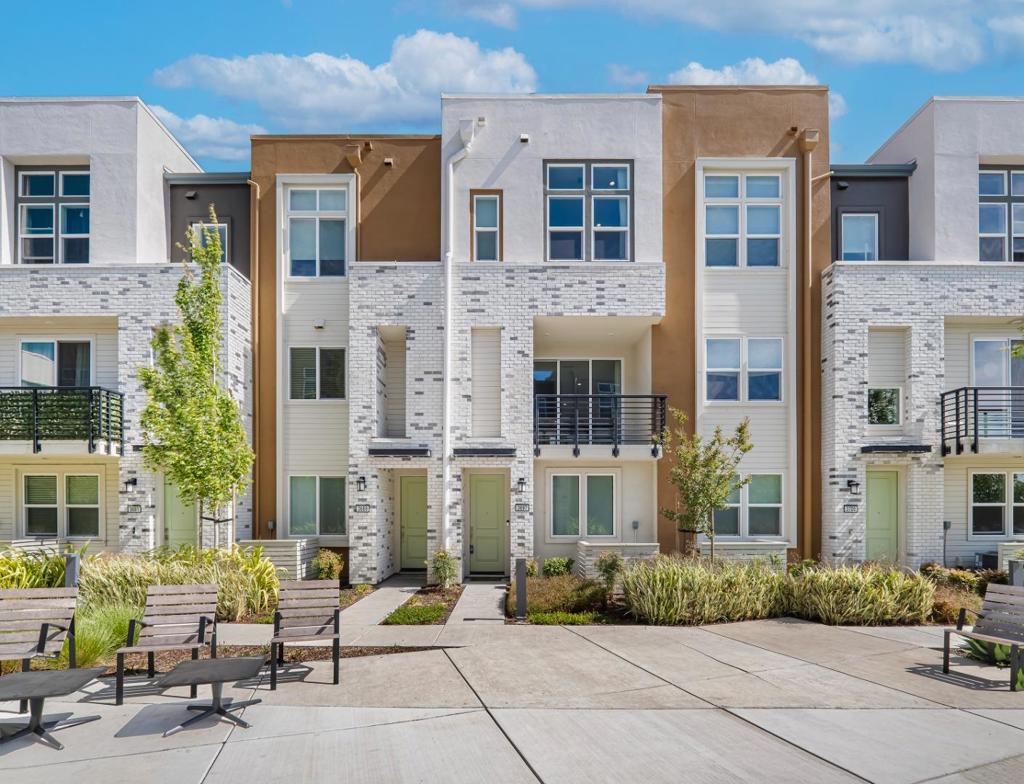 Wonderful opportunity to own a stunning, low-maintenance townhome in the sought-after Metro West community in Fremont. Just 3 years new, this beautifully upgraded home with over $50,000 in improvements offers an open and airy floor plan filled with natural light, soaring ceilings, and elegant luxury vinyl plank flooring. The kitchen showcases quartz countertops, high-gloss cabinetry, KitchenAid stainless steel appliances, and a spacious island perfect for cooking and casual entertaining. Full-height luxury cabinets provide ample storage and a polished, modern look. Upstairs, two generously sized bedroom suites offer peaceful retreats with lofty ceilings. One suite features a walk-in closet and a spa-like bathroom with dual vanities, while the second suite includes its own full bathroom, ideal for guests or a dedicated home office. The 2-car tandem garage offers plenty of room for parking and additional storage. Equipped with energy-efficient appliances, smart thermostats with dual zones, solar panels, and pre-wired wireless connectivity for seamless modern living. Enjoy convenient access to nearby parks, shopping, dining, BART, and Hwy 880 & 680. Don't miss the chance to make this your home!
