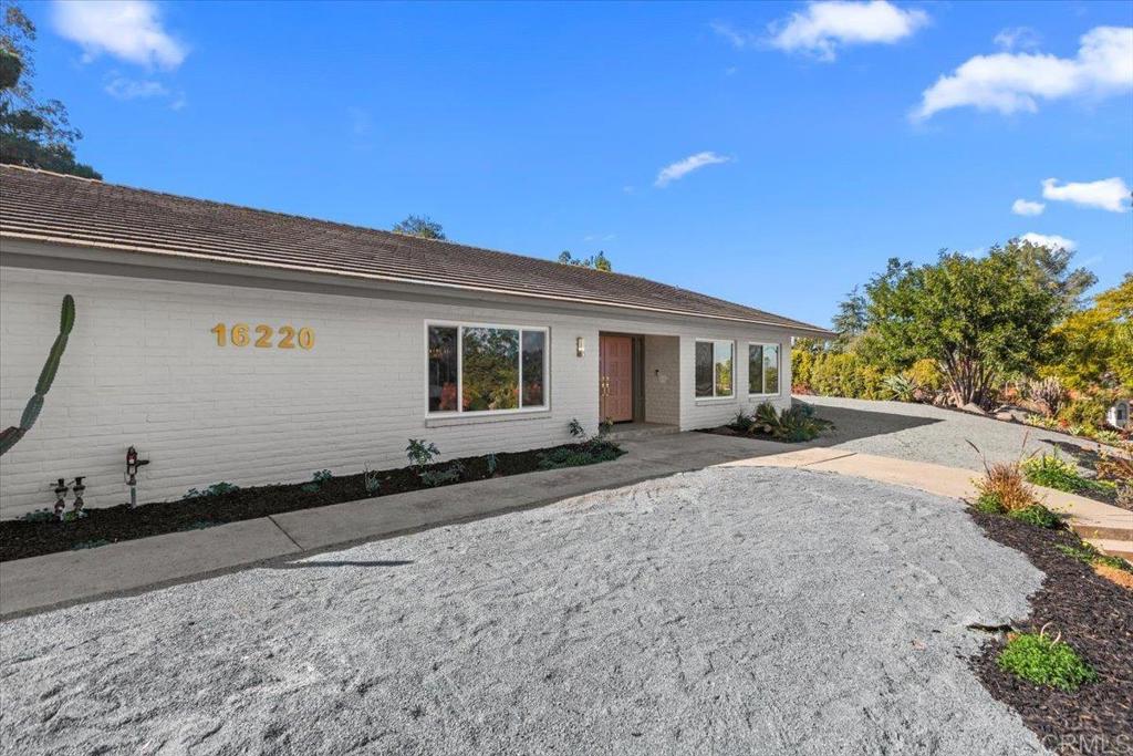 Discover this exquisite, newly remodeled single-story home nestled in a highly desirable Poway neighborhood of custom homes. Offering 5 bedrooms and 4 baths, this residence sits on half an acre, providing both privacy and breathtaking hillside views. Step inside to a bright, open-concept design featuring elegant finishes and modern upgrades throughout. The chef’s kitchen is a showstopper, boasting top-of-the-line appliances, sleek quartz countertops, custom cabinetry, and an expansive waterfall peninsula—perfect for entertaining. The spacious living and dining areas are enhanced by large windows and sliding doors, inviting abundant natural light and seamless indoor-outdoor living. The primary suite is a true retreat, featuring a spa-like ensuite bathroom with a luxurious soaking tub, dual vanities, and a walk-in shower. Additional bedrooms offer generous space, ideal for guests, home offices, or playrooms. The fully renovated bathrooms feature stylish fixtures and high-end finishes. Outside, enjoy the yard designed for both relaxation and entertaining, with lush landscaping and ample space for an outdoor kitchen or whatever you can envision. The long driveway leads to a four-car garage, while an arched driveway offers additional parking for up to 10 vehicles, an RV, or outdoor toys. Additional upgrades include new flooring, fresh interior and exterior paint, a brand-new HVAC system, and a new water heater—ensuring comfort and efficiency for years to come. Conveniently located near top-rated schools, shopping, dining, and outdoor recreation, this turn-key home offers the perfect blend of luxury, space, and modern living. Don’t miss out on this beautifully transformed property—schedule your private tour today!