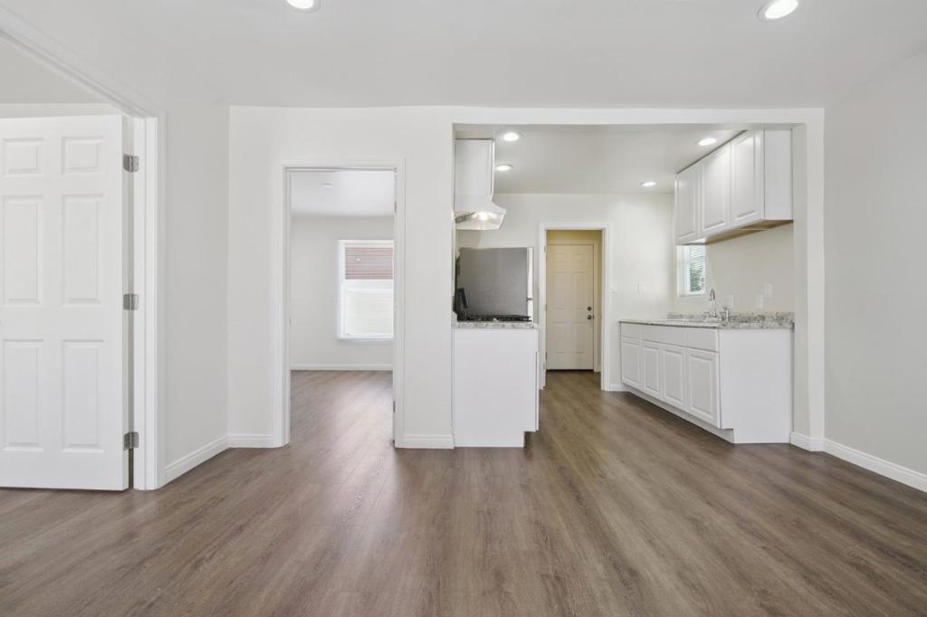Bright, inviting, and freshly updated, this two-bedroom, one-bath home offers a polished space. Warm-toned flooring flows throughout, creating a rich contrast against the light walls and crisp white trim. Recessed lighting adds a clean, modern touch while keeping each room well-lit from morning to night. Both bedrooms are similar in size, offering flexibility for your lifestyle needs - whether thats a restful retreat, a productive home office, or a welcoming space for guests. The bathroom feels fresh and functional, with a roomy walk-in shower framed by sliding glass doors and a high-set window. In the kitchen, white cabinetry pairs with stone-patterned counters. The galley-style layout offers generous prep areas and plenty of storage above and below, making it easy to keep everything organized. Just steps away, the dedicated laundry room includes hookups so you can bring your own washer and dryer for added convenience. Located directly across from South Los Angeles Wetlands Park, youll enjoy access to walking trails and beautiful natural views whenever you need a breath of fresh air. The neighborhood sits in Southeast Los Angeles, putting local restaurants, shops, and everyday conveniences within easy reach, while downtown Los Angeles is just a short drive away.