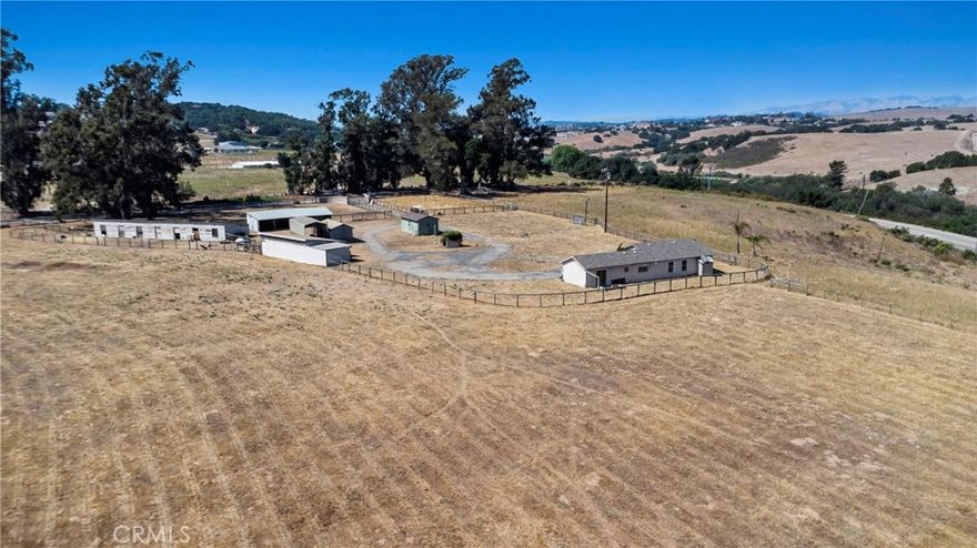 Situated in picturesque Arroyo Grande, this exceptional 12.63± acre ranch offers gently rolling terrain, level pastures, and versatile land ideal for horses or agricultural use. The property showcases the serenity of country living while remaining just minutes from everyday conveniences. A charming single-story home features 3 bedrooms, 2 bathrooms, and approximately 1,216 square feet of comfortable living space. The fully fenced parcel is well-equipped with horse stalls, a hay barn and multiple outbuildings. In addition, the parcel may offer the opportunity to be split into multiple lots, creating exciting development potential—investors are encouraged to confirm possibilities with the county and/or an architect.