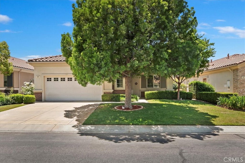 Welcome to Resort-Style Living in Solera at Oak Valley Greens! This beautiful Trillion model offers 2 spacious bedrooms, 2 full bathrooms, and approximately 1,686 sq. ft. of comfortable living space! Located in one of Beaumont’s most sought-after 55+ gated communities, this home offers a spacious open floor plan. The kitchen boasts Corian countertops, ample cabinet space, a pantry, stainless steel appliances, and pullouts in every cabinet. The kitchen opens to the family room with a fireplace and built-in entertainment center. The large sliding door allows plenty of natural light and access to the backyard. With the added Aluma-wood extended patio cover which goes across the entire back of the home, allowing for plenty of shaded space to relax and enjoy the sunset. The primary suite includes a large walk-in closet, dual vanities, and a separate shower and soaking tub. The guest bedroom has direct access to the guest bath which includes a step-in jetted tub. Enjoy indoor laundry with built-in cabinets & sink with direct access to the garage with space for your golf cart! Residents enjoy access to a clubhouse with fitness center, pool & spa, bocce ball, tennis, walking trails, and countless social activities. This is a peaceful, well-maintained neighborhood. Don’t miss this opportunity to own in Solera — schedule your private showing today! DISCLAIMER: some photos have been AI staged due to clutter in home at the time of photos. All clutter will be removed before the close of escrow.