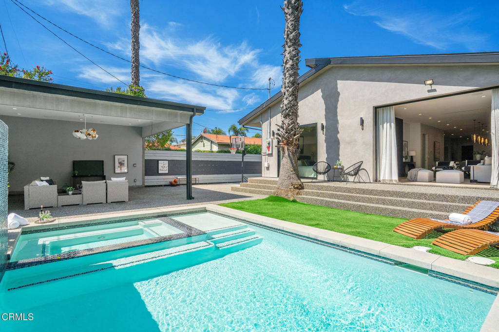 Discover modern elegance in this recently renovated home that features 5 bedrooms and 6 bathrooms. This quintessential residence was designed with sophistication and impeccable taste, boasting an open floor plan and soaring 10' ceilings that invite an abundance of natural light. The heart of the home is the gourmet chef kitchen, featuring a 12' central island with a 6' breakfast bar, pot filler, and quartz countertops, ideal for culinary enthusiasts. Adjacent to the immaculate kitchen is the gorgeous dining area with a signature chandelier and a gorgeous wine rack, creating the perfect entertainer's space or just a night to unwind. The inviting living room is adorned with a captivating modern fireplace, making it such a warm and enjoyable room to relax. Quintessential California indoor-outdoor living at its best - Seamlessly transition between the living room and the outdoor through the 12' sliding pocket doors, opening to a serene backyard with a sparking pool and fountain, cabana, and built-in BBQ. The private backyard is a nature hideaway from the hustle and bustle. The spacious primary suite offers a direct access to the pool, creating a personal oasis. The exquisitely renovated and oversized en-suite bathroom is complete with double sinks, enclosed water closet and shower. Each bedroom is a private sanctuary, complete with its own en-suite bathroom adorned with designer marble tiles, custom cabinetry, and frameless shower doors.The home is centrally located to the Westside, Santa Monica, Ventura Blvd's amazing eateries, shops, cafes and lounges, DTLA, Studio City, Costco, Trader Joe's and Starbucks. Come see your future home - the perfect blend of luxury and convenience.