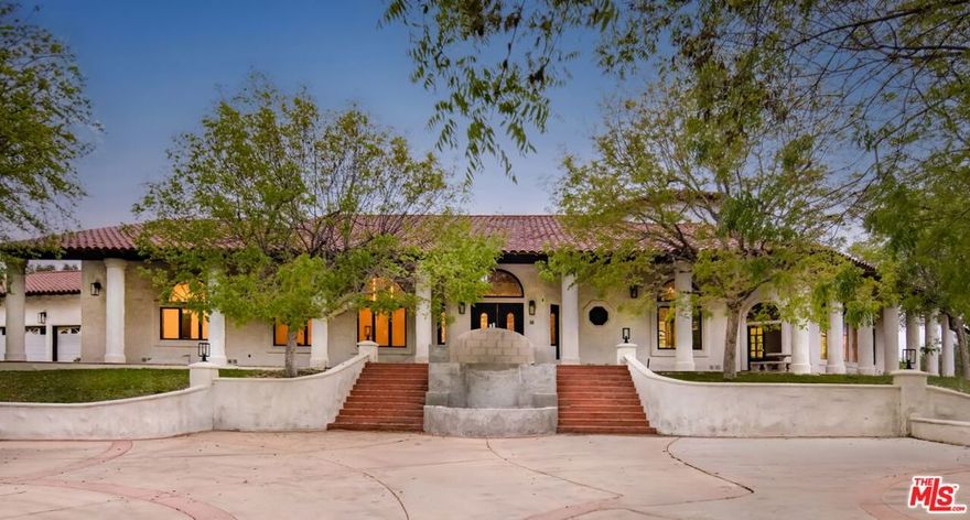 The Valley Ranch Estate - A rare and remarkable opportunity to complete a timeless, gated compound of exceptional scale and vision. Privately tucked away atop a scenic bluff, this architectural gem is accessed via a long, winding driveway that reveals a commanding presence - an estate where grandeur meets potential. Spanning 9.09 acres - this estate includes a championship North/South tennis court with professional lighting, RV parking, and an expansive motor court with a true circular driveway and a four-car attached garage. The custom-built residence unfolds with dramatic effect: a soaring foyer welcomes you into a voluminous great room with cathedral ceilings, exposed beams, and walls of glass that frame panoramic mountain views. A tucked-away, fully equipped bar adds to the grandeur, perfect for entertaining in effortless style. The open-concept gourmet kitchen features a massive center island and seamless flow to the entertaining spaces. Four generously appointed bedrooms on the main level provide comfort and privacy, while a spacious laundry room offers ample storage and utility. Above it all, the primary suite is a sanctuary unto itself - an expansive retreat with its own private stairway, dual spa-inspired bathrooms, sitting area, steam shower, dedicated storage, and uninterrupted views of the surrounding mountains. Outside, a sun-drenched pool and spa are gracefully framed by mature oak trees, offering tranquility and natural beauty. This estate is a canvas awaiting its final brushstrokes - a unique opportunity for discerning owners or visionary developers to craft a generational compound.