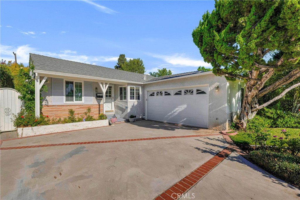 Discover this inviting 3 bedroom, 2 bath mid-century rambler in the heart of Sherman Oaks, offering 1,400 sq ft of living space on a 6,752 sq ft lot with timeless character and opportunity to update and reimagine to your tastes. Great curb appeal with lush front lawn, abundant roses, mature shade trees, and brick accents to the drive and the front porch, creating a striking first impression. Fresh interior paint and carpet throughout! The formal entry leads to a welcoming living room with a striking, stacked stone, fireplace, crown molding, and a sliding glass door opening to the backyard. The adjoining dining area features decorative wainscotting, pitched ceiling with exposed beams, built-in shelving, a window seat, and direct yard access. The kitchen blends warmth and function with wood cabinetry, stone counters, and stylish tile backsplash. The home offers three bedrooms including a spacious primary suite with crown molding, private stacked stone fireplace. Dual closets, and an en-suite ¾ bath. Two additional good-sized bedrooms share a ¾ hall bath. The attached 2-car garage includes a dedicated laundry area. Additional features include dual pane windows and a whole-house fan. Outdoors, a lush retreat awaits with a concrete patio, partially covered, accented by brick ribbons, walkways edged in brick, verdant lawn, mature trees, and bordering hedges for added privacy. Wonderfully situated in a quiet, friendly, residential neighborhood near highly rated schools, shopping, dining, entertainment, recreation, the excitement of Ventura Blvd and the natural space of the Sepulveda Basin Recreation Area. Don’t miss this opportunity for a rare property with timeless character, abundant space, and incredible potential in a prime location.