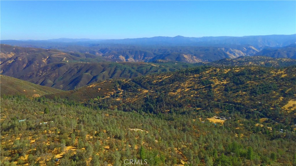 Beautiful 16+ acres with Panoramic Views of the Merced River Basin & beyond, including Yosemite National Park! A graveled driveway takes you up to the Well House, Water Storage Tank, & Storage Shed. Nestled in the shade of Oaks & Pines, there is a pop-up camp trailer that might be negotiated in. Gorgeous stands of Junipers adorn the landscape. Subject property borders several parcels of BLM Land; there is beautiful, seasonal pond located on the 40 acre BLM parcel. This would be an excellent prospect for off-grid living.