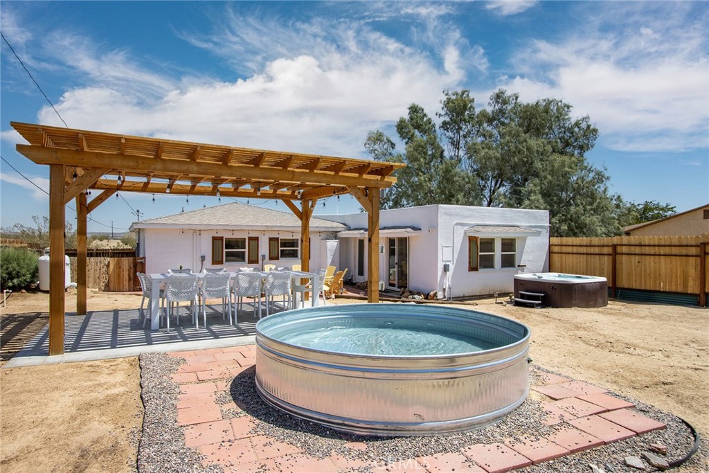 Short-Term Rental Opportunity + Detached Garage/ADU Potential!
This spacious 4-bedroom, 2-bath desert home features a comfortable master suite and sits on over 0.55 acres of land — just minutes from Joshua Tree National Park and popular local attractions. Inside, enjoy polished concrete floors, a ductless mini-split HVAC system, a beautifully updated kitchen with concrete countertops and full-height tile backsplash, and two spa-like baths.
Step outside to a private, fenced yard with a covered patio, hot tub, fire pit, BBQ area, and a detached garage/studio — perfect for relaxing under starry skies. The garage is equipped with a septic tank, electricity already in place (no panel), and drain-side plumbing, making future improvements or a garage-to-ADU conversion simple and cost-effective.
Whether you’re looking for a move-in-ready primary home, a turnkey Airbnb, or a property with income potential, this peaceful desert oasis is packed with character and limitless possibilities. Don’t miss this rare opportunity!