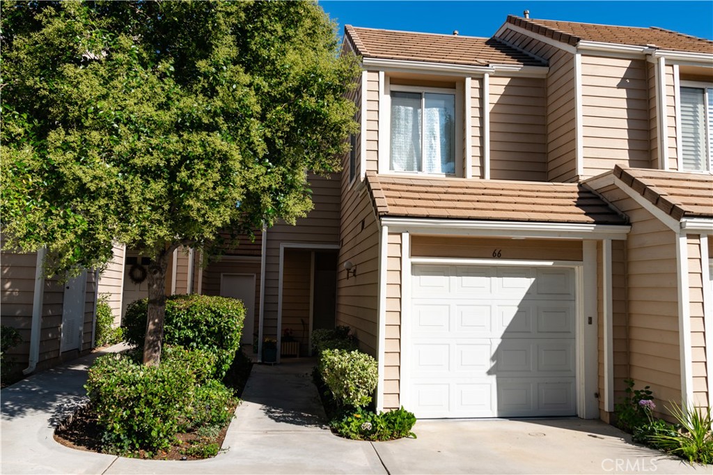 This beautifully updated townhouse in the sought-after Franciscan Hill community offers style, comfort, and a prime Valencia location. Bright and airy with abundant natural light, the home features shutters throughout and a private, two-level layout with no shared neighbors above or below. Inside, enjoy modern upgrades including LVP flooring, fresh paint, recessed lighting with dimmers, new baseboards, and two stylish wood feature walls. The updated fireplace with glass and ceramic logs is framed by custom mantels (2021), creating a warm focal point in the living space. The remodeled half bath, updated vanity, new faucets, and chic light fixtures add to the fresh feel, while the newer stove (2022), Brio water filtration system, and newer water heater (2021) bring everyday convenience. Upstairs, a skylight fills the hallway with soft, natural light. The two spacious bedrooms each offer their own ensuite bathrooms and walk-in closets for generous storage. One bedroom includes a cozy fireplace, adding warmth and charm to the retreat. Recent updates include new carpet on the stairs (2023) for a fresh, comfortable feel. The HOA covers trash, exterior pest maintenance, patrolled security, common area upkeep, and access to the community pool and spa, all with no Mello Roos. An additional assigned carport parking space complements the direct-access garage with epoxy flooring. Conveniently located near Henry Mayo Hospital, CalArts, shopping, dining, and quick 5 Freeway access, this home blends comfort, convenience, and community in one desirable package!