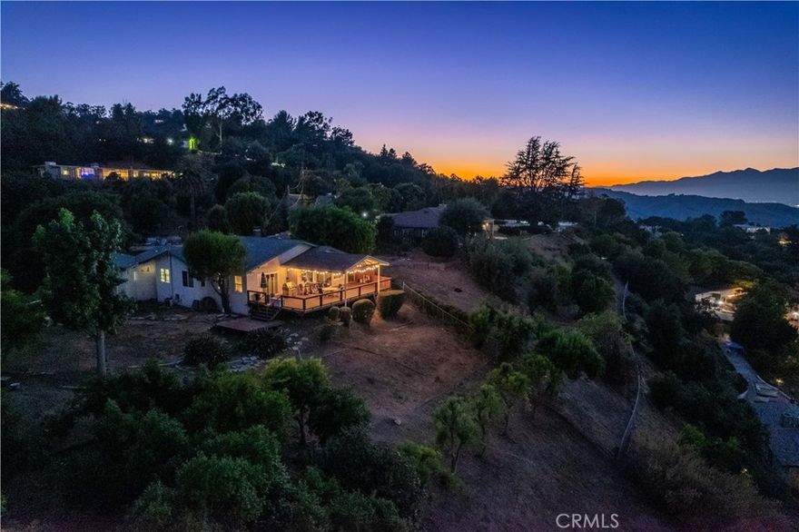 Welcome to 2699 Turnbull Canyon Road, a hidden retreat tucked away on a private road in the hills of Hacienda Heights, in the very sought-after neighborhood of Turnbull Canyon. This home offers something truly special—breathtaking views, privacy, and the comfort of nature all around you. From your deck, you can take in sweeping panoramas of twinkling city lights, snow-dusted mountains in the winter, vibrant sherbet skies at sunset, and dazzling fireworks on the Fourth of July. It’s the kind of view you’ll never tire of, one that makes you pause and feel grateful to call it yours. The home sits on an acre of land with plenty of usable space, giving you both room to grow and the seclusion you desire. Step inside and you’ll find a warm, welcoming floor plan with a formal living room centered around a cozy fireplace, a dining area made for gathering, three comfortable bedrooms, and three bathrooms, plus a separate den that could easily serve as a spacious bedroom. Nearly every window invites the outside in, framing either the sparkling city views or the peaceful canyon that surrounds you. The kitchen and windows have been thoughtfully updated, while the basement provides endless possibilities—whether you dream of extra living space, workshop, or simply a place to store your treasures. The fourth bedroom was once a detached granny studio, now seamlessly connected to the main home, offering flexibility for extended family, guests, or a private primary bedroom with its own bathroom. This property offers a 2 car garage and plenty of Parking for RV, Boat, or recreational toys. Outside, mature trees, natural walking paths, and nearby trails invite you to slow down, breathe, and enjoy the beauty of Turnbull Canyon. And while the setting feels like a world away, you’re still only minutes from schools, shops, markets, and freeway access. Turnbull Canyon is known for its charm—where hillside estates and cozy hideaways come together in one of Hacienda Heights’ most beloved communities. This property is ready for its next chapter, waiting for someone to bring their personal touch and make it their own. 2699 Turnbull Canyon Road isn’t just a home—it’s a sanctuary, a gathering place, and a chance to live surrounded by beauty every single day. A place where every day feels like a retreat.