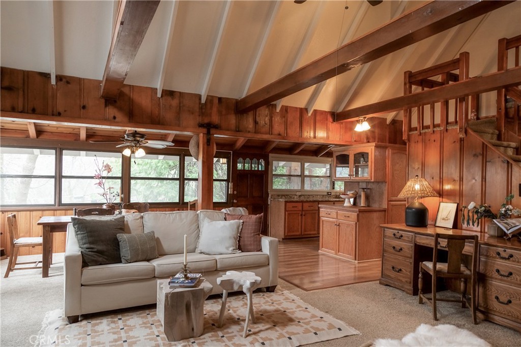 This unique and charming mountain home exudes warmth and character, featuring a classic pine interior, indoor hot tub made for fun and a brick fireplace with wood-burning insert. Located just moments from Lake Drive, you can easily enjoy local coffee, restaurants and shopping. With a thoughtfully remodeled and well-updated modern kitchen, it strikes a combination of old-world allure and contemporary living making this mountain property truly special. Bedroom one is a cozy nook, perched above the open beamed living room, while a second bedroom is on the main level and has a large walk-in closet. Unwind on the expansive deck; or enjoy endless fun in a unique treehouse, thoughtfully equipped with electricity, bunk beds, two lookout posts connected by a bridge, a zip line and slide. This extraordinary play fort offers a magical retreat filled with adventure! Nestled away from the hectic pace of daily life but a quick drive from the city below, this property provides a serene getaway while still being close to various conveniences. The newly rebuilt Goodwin’s Market presents a delightful selection of rare and gourmet foods to elevate your mountain retreat experience. Whether you're looking for a full-time home, weekend retreat or vacation rental, this captivating home promises to create a lifetime of cherished memories.