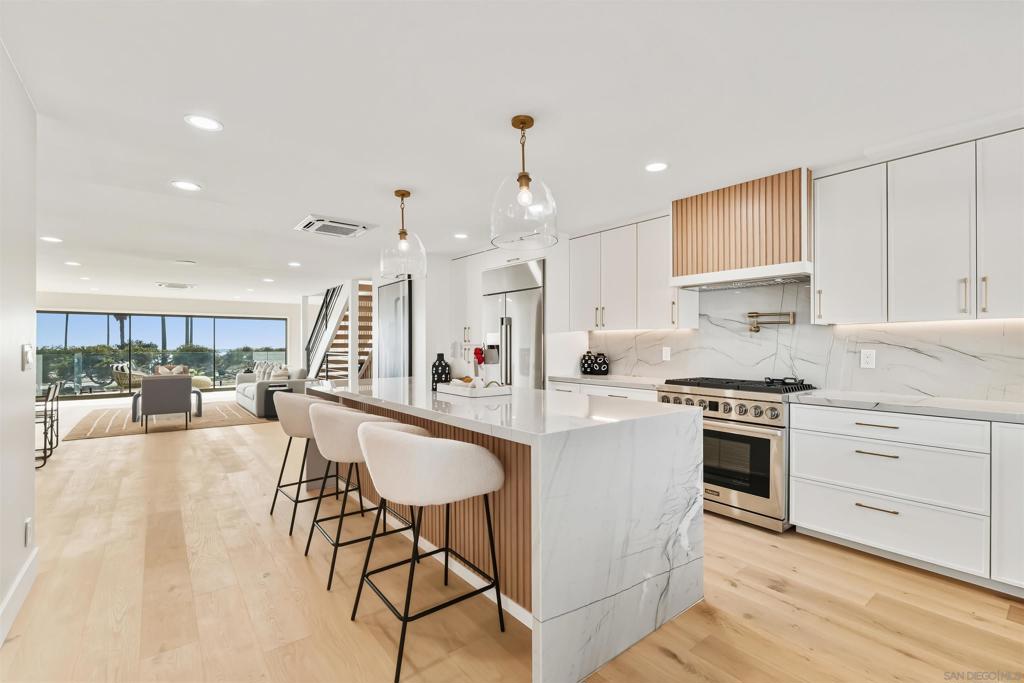 The most private location on Ocean Front Walk! Entertainer’s Dream with Expansive Views! This fully remodeled 5-bedroom coastal retreat is the ultimate San Diego beach house. Designed for entertaining, the outdoor spaces feature multiple decks, a spacious patio with Bromic heaters, Sonos speakers, firepit with seating for 10+, a built-in BBQ, and a wellness area complete with hot tub, cold plunge, and sauna. Natural light pours through Fleetwood doors and Marvin windows, framing breathtaking views of Mission Beach, whitewater in Ocean Beach, boats cruising out to sea, and the cliffs of Sunset Cliffs illuminated at night. The main level boasts open-concept living with a custom kitchen featuring quartzite countertops, wood shaker cabinetry, Dacor appliances, wet bar, and seamless indoor-outdoor flow to the deck. Upstairs, the private primary retreat offers dual closets, a spa-like bath with marble finishes, and panoramic ocean vistas. Two additional bedrooms share their own bath with marble countertops and enjoy access to an east-facing deck for sunrise views. Downstairs, a secondary living/game room with wet bar provides additional entertaining space, along with two more bedrooms and a full bathroom. Newly laid pavers surround the property, creating a clean and modern coastal vibe. Parking for 3 cars included. This home is a rare opportunity to own a luxury entertainer’s paradise in one of San Diego’s most iconic beach communities.