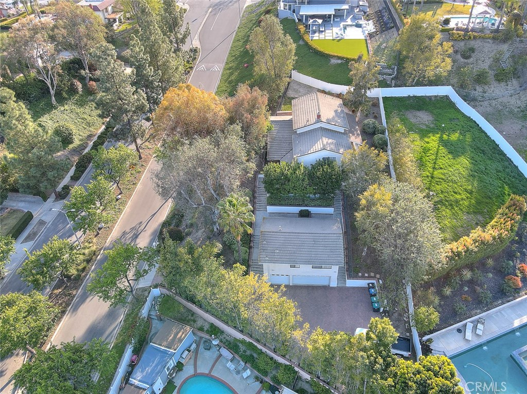 Located in the Highly desirable City of Chino Hills, a truly unique property situated on an elevated & very private lot. The main house has 4 bedrooms & 3 bathrooms & the three car garage features a 1 bedroom/1 bath apartment on the second story. The driveway boasts pavers that lead all the way to a sizeable parking area at the base of the property. The detached 3 car garage & apartment are on the lower portion of the lot. Occupants of the apartment could easily use one set of stairs for access & the upper level primary home offers privacy as it is situated on the top portion of the lot. Entry hall leads to a nicely sized formal living/dining space with a large picture window that allows for soft natural light & an appreciation of the unique views of mature trees this setting provides. Kitchen, large breakfast room for casual secondary dining & a family room with an inviting fireplace are also on this level. Kitchen has oak cabinets, upgraded counter, recessed lighting & stainless appliances. Oversized primary suite enjoys a view balcony and on-suite 3/4 bathroom & 2 other guest bedrooms are on the upper level of the home. Secondary bedrooms are quite large & 2 of them share a Jack & Jill bathroom. One of the upstairs guest bedrooms features built-ins & desk seating, perfect for a student. The lower level of the home has a 4th bedroom, 3/4 bathroom & indoor laundry room. Sliders from the family room lead to the covered patio, a perfect spot to enjoy outdoor guests, cup of morning coffee or summer barbecue. The top of the lot has a large grass area & additional storage shed. There is a nice courtyard space in between the main home & apartment that could also be enjoyed for outside entertaining. The apartment has a nicely sized living room w/corner desk built-ins. A separated room with kitchenette & space to dine, closet, bedroom & 3/4 bath. Would be a wonderful source of extra income, possible guest quarters or whatever best suits the next owners of this special property. Chino Hills boasts highly rated schools, multiple parks, hiking & biking at the state park, an outdoor mall "The Shoppes" w/many shopping & dining choices, Costco, Trader Joes & more. This home is centrally located to area shopping & dining choices. Close proximity to Orange County is also considered a plus by many & the rolling foothill setting of Chino Hills gives this community a beauty not found everywhere. Newly installed exterior stair railing is a wonderful addition to the property!