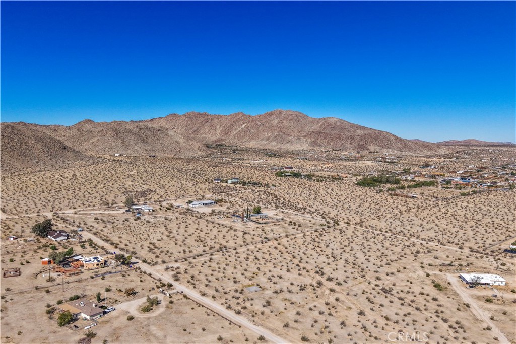 Exceptional opportunity to own 2.5 acres of land in the desirable Old Town West area of Joshua Tree. This spacious parcel offers inspiring panoramic views of the surrounding mountains and desert landscape, providing an ideal canvas for your dream home, modern retreat, or investment property. Buyer to verify availability and access to utilities.
Located close to downtown Joshua Tree, you’ll enjoy easy access to local restaurants, art galleries, and live music venues, along with community favorites like the Joshua Tree Music Festival and weekly Farmers Market. Just a short drive from the west entrance of Joshua Tree National Park, this property combines the tranquility of open space with the creative energy of one of the desert’s most vibrant communities.