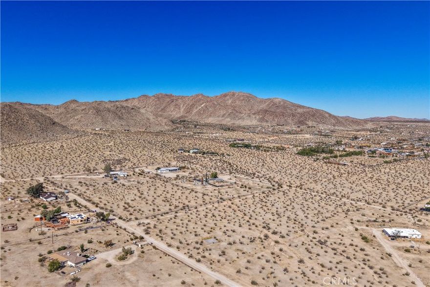 Exceptional opportunity to own 2.5 acres of land in the desirable Old Town West area of Joshua Tree. This spacious parcel offers inspiring panoramic views of the surrounding mountains and desert landscape, providing an ideal canvas for your dream home, modern retreat, or investment property. Buyer to verify availability and access to utilities.
Located close to downtown Joshua Tree, you’ll enjoy easy access to local restaurants, art galleries, and live music venues, along with community favorites like the Joshua Tree Music Festival and weekly Farmers Market. Just a short drive from the west entrance of Joshua Tree National Park, this property combines the tranquility of open space with the creative energy of one of the desert’s most vibrant communities.