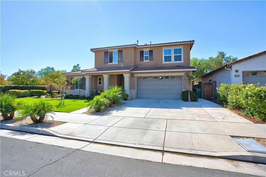 MOVE IN READY! Welcome to this lovely home with a bright, open floor plan that's perfect for everyday living and entertaining. You'll love the spacious great room right off the kitchen, ideal for gatherings with family and friends. This spacious family room allows you to relax and enjoy the views of the beautiful landscaping and nearby hills and mountains. The gourmet kitchen features granite countertops, mocha cabinetry, extra cabinets, double oven, 5 burner cook top, large island with breakfast bar and a nice size pantry. Just off the kitchen is a formal dining area and from there you'll find a full downstairs bedroom and bathroom. Perfect for guests or a comfortable home office. As you head upstairs there are three additional bedrooms plus an open loft featuring extra recessed lighting. a perfect entertainment area and for a pool table. The convenient upstairs laundry room adds even more functionality. Outside, enjoy a private backyard with a block wall, large side yard, Alumawood patio cover with a ceiling fan ideal for relaxing or hosting gatherings. The oversized three car garage provides plenty of space for parking and storage with epoxy flooring and has a tankless water heater. So many HOA amenities include 2 pools, lake, splash park for kids, pickleball, tennis courts and much more! A must see!