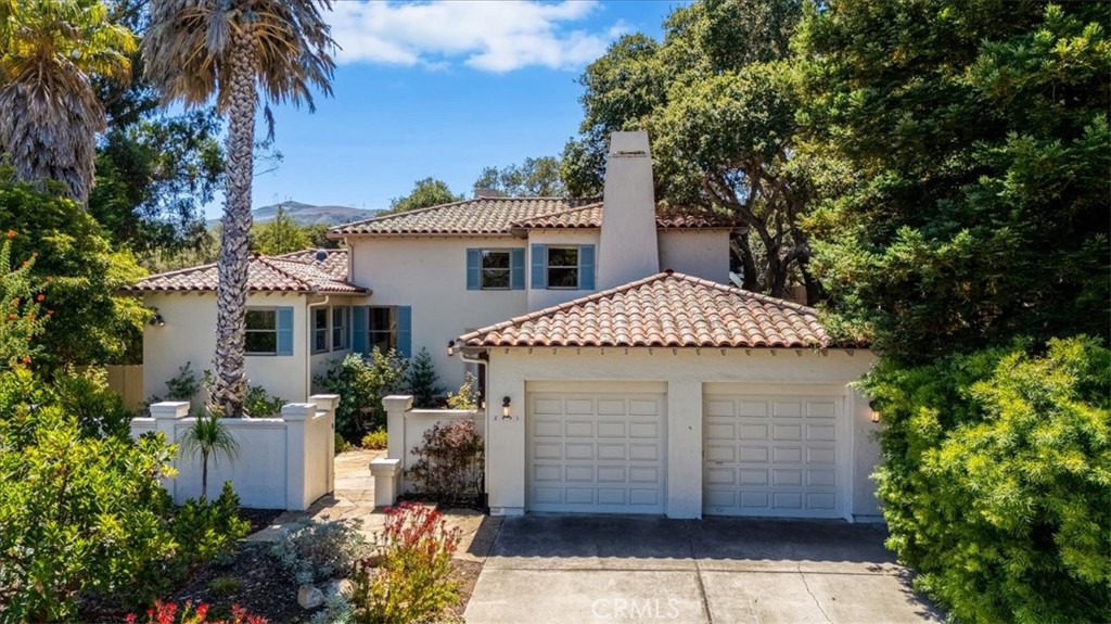 Coastal-Inspired Villa in Bayridge Estates
Welcome to a peaceful, coastal-inspired villa nestled in the highly sought-after Bayridge Estates. Tucked away at the end of a quiet cul-de-sac and elevated on a gentle slope, this home enjoys both enhanced privacy and scenic surroundings. Set on expansive, park-like grounds, the property features mature trees and native plants thoughtfully selected for both beauty and sustainability. Artisan pavers trace graceful paths through the garden leading to multiple private patios—ideal for al fresco dining, stargazing, or taking in the sunset views. A serene, gated front courtyard sets the tone of secluded tranquility. Inside, you'll find European white oak hardwood floors, rooms bathed in natural light, and timeless architectural details that carry a warm, inviting atmosphere throughout. This 3-bedroom, 2-bathroom home offers approximately2563 square feet of living space. The living room is anchored by a grand fireplace flanked by generous windows that frame views of the lush backyard. On one side, it flows into a sun-drenched family or bonus room with French doors which open onto the back patios. On the other side, a window-lined dining room with French doors invites seamless indoor-outdoor living and views of the evergreen Coast Live Oaks. The kitchen is as stylish as it is functional, offering abundant cabinetry, stainless steel appliances, a charming breakfast nook, and lovely courtyard views. The first bedroom is spacious, with semi-en suite access to a full bathroom and views of the front courtyard. The generously proportioned second bedroom (or optional media room / home office) provides for a flexible layout and features a fireplace focal point. The primary suite includes ample closet space, peaceful garden views, and a bonus secluded retreat—ideal for a reading nook or private office. The suite also connects to a Jack-and-Jill bathroom with a deep soaking tub and dual vanities. Just out the back gate you'll find trails that lead past a eucalyptus grove and the stunning natural beauty that surrounds the area. Enjoy the charm of nearby coastal eateries and shops. With easy proximity to both San Luis Obispo and Morro Bay, this coastal retreat blends tranquility, timeless charm, and everyday convenience.
