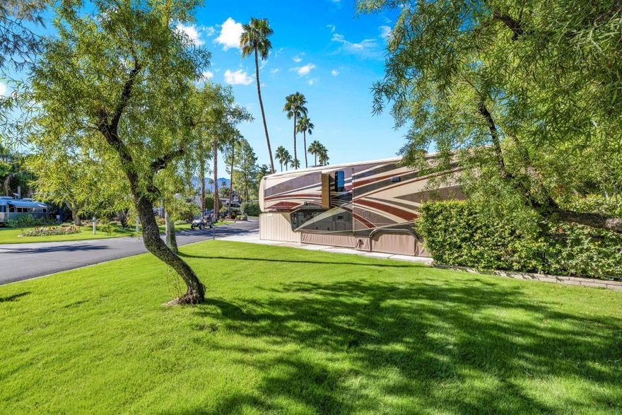 This exceptional corner lot is strategically positioned adjacent to expansive open space, providing an enhanced sense of privacy and tranquility. Its prime location ensures unparalleled convenience, with the starter shack, a satellite pool and spa, and the main clubhouse all within easy walking distance.The lot itself has undergone significant enhancements,  featuring a newly expanded  6-inch thick concrete pad. State of-the-art electrical and irrigation systems, alongside premium synthetic turf, ensuring minimal upkeep and year-round aesthetic appeal. Established, mature privacy hedges provide  natural shade, further enhancing the comfort and privacy of the space.This property  includes high-quality patio furnishings, ready for immediate enjoyment.