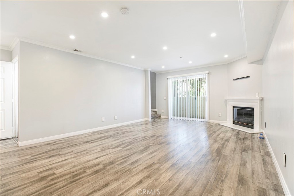 Beautifully Renovated 2-Bedroom Townhouse-Style Condo in Van Nuys. Discover this spacious and stylish 2-bedroom, 3-bathroom townhouse-style condo offering 1,456 sq ft of modern living in the heart of Van Nuys. Perfect for first-time buyers or savvy investors, this move-in ready home features direct garage access, an open floor plan, recessed lighting, crown molding, and laminate flooring throughout. The sleek kitchen boasts quartz countertops, stainless steel appliances, custom cabinetry, and a chic breakfast bar with pendant lighting. Each bathroom has been thoughtfully updated with designer tilework and modern finishes—including a luxurious primary bath with soaking tub and glass-enclosed shower. Both bedrooms are generously sized with walk-in closets. Enjoy added comforts like a cozy fireplace, private balcony, in-unit laundry, new central air & heat, and a large private storage unit. Located in a well-maintained building with guest parking and easy access to shopping, dining, and major freeways—this property blends comfort, convenience, and value in one turnkey package.