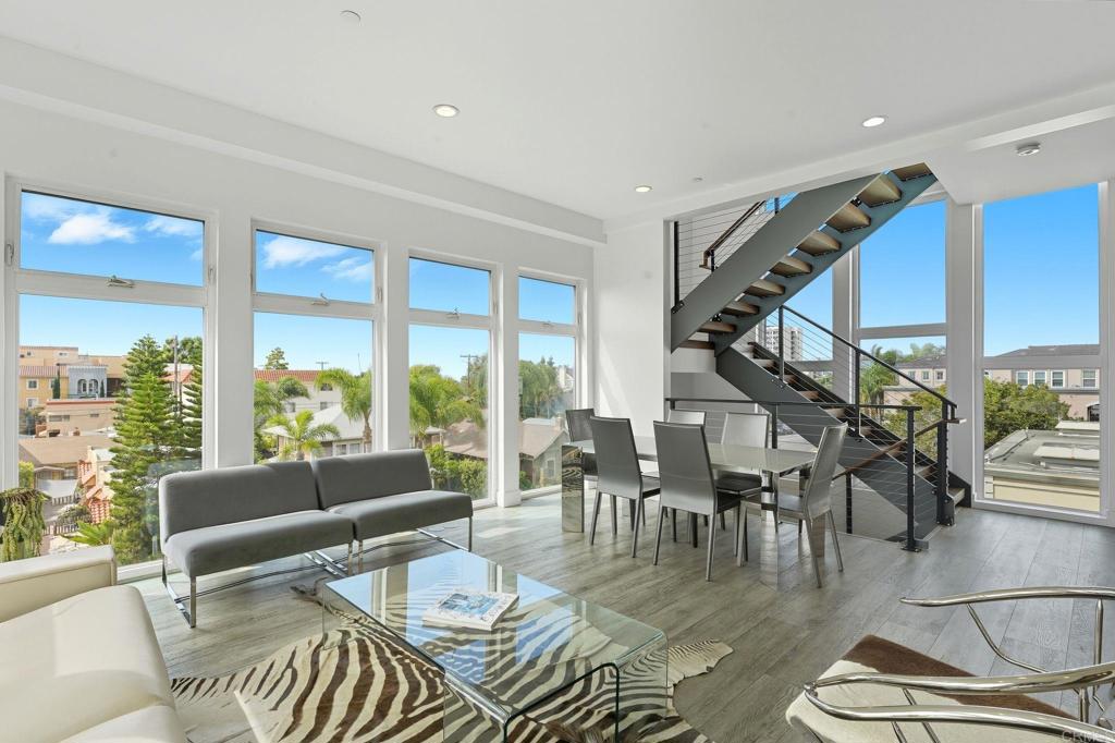 Experience modern luxury in the heart of Hillcrest! This stunning tri-level townhome offers over 2,100 sq ft of open-concept living space, blending contemporary design with urban convenience. The gourmet kitchen features quartz countertops, premium stainless steel Samsung appliances, custom cabinetry, and a spacious island perfect for entertaining. Expansive living areas showcase high ceilings, abundant natural light, and sleek finishes throughout. Enjoy multiple private terraces, including an impressive rooftop deck with panoramic city views—ideal for relaxing or hosting guests. Additional highlights include a ground-floor flex space, in-unit laundry, and a two-car tandem garage with direct access. Located near Balboa Park, top restaurants, cafés, and the vibrant Hillcrest Farmer’s Market. This sophisticated residence captures the very best of Uptown San Diego living!