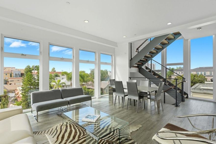 Experience modern luxury in the heart of Hillcrest! This stunning tri-level townhome offers over 2,100 sq ft of open-concept living space, blending contemporary design with urban convenience. The gourmet kitchen features quartz countertops, premium stainless steel Samsung appliances, custom cabinetry, and a spacious island perfect for entertaining. Expansive living areas showcase high ceilings, abundant natural light, and sleek finishes throughout. Enjoy multiple private terraces, including an impressive rooftop deck with panoramic city views—ideal for relaxing or hosting guests. Additional highlights include a ground-floor flex space, in-unit laundry, and a two-car tandem garage with direct access. Located near Balboa Park, top restaurants, cafés, and the vibrant Hillcrest Farmer’s Market. This sophisticated residence captures the very best of Uptown San Diego living!