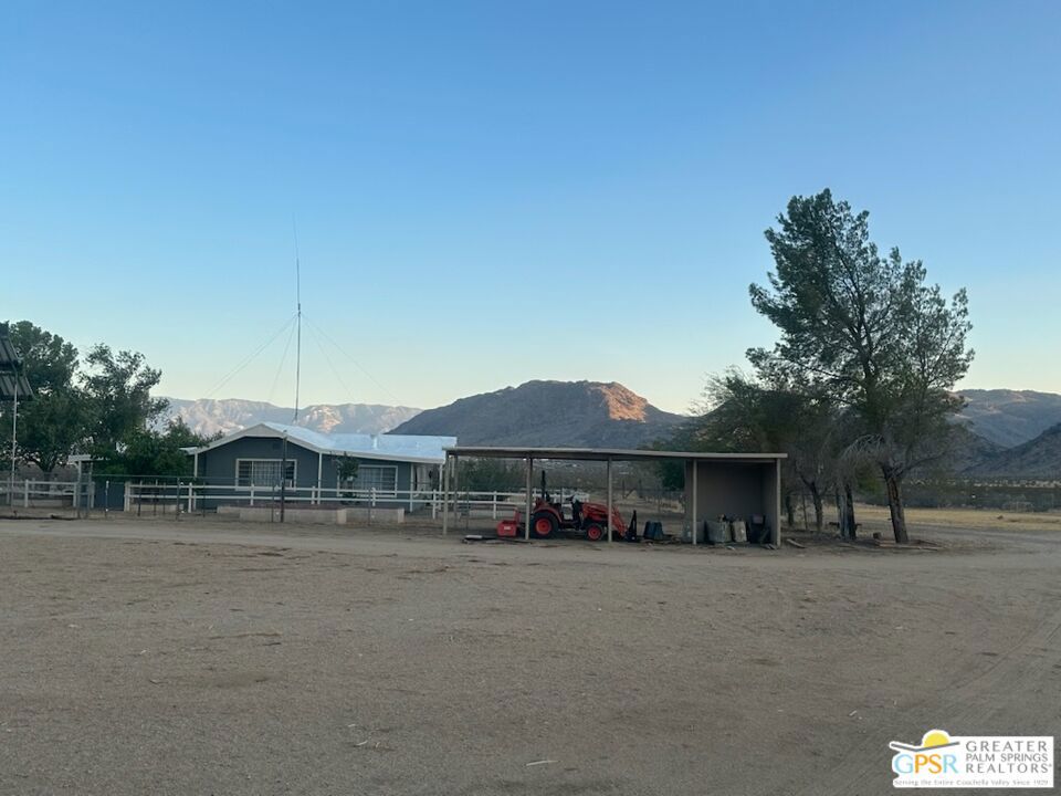OFF GRID! Mountain views !! This 20 acre secluded desert property is designed for self-sufficient living, featuring an impressive solar power system with 24 400-watt solar panels, 6 Bloom batteries, and a Solar Ark 12K inverter, installed in August 2024. Water is plentiful with two water tanks (1000 and 5000 gallons) and a well with two pumps. The property also includes adequate septic tanks. The 2 bedroom one bath main house boasts a remodeled kitchen with new flooring and appliances, along with window air conditioners and two cozy wood-burning fireplaces. For more accommodations, you'll find a remodeled manufactured guest house measuring 10 by 50 feet with 2 bedrooms and 1 bathroom, perfect for visitors or rental income. There are also five versatile shelters on the property. Enjoy the additional unique outdoor enclosed bath with a shower and hot water, offering a convenient refreshing experience. Two propane tanks supply all needed appliance usage. Practical amenities include a garage and barn for storage and projects. Diesel 4 wheel drive tractor includes front loading bucket and forklift, and rear gannon for finishing roads. The entire property is completely fenced with three gates for privacy and security. The roofs on the main house, guest house, and garage were replaced two years ago, ensuring durability and peace of mind. May be used as horse ranch, farm, or short term rental as well as an off grid paradise. Available for showings by appointment. Don't miss out on this!! CALL NOW!!