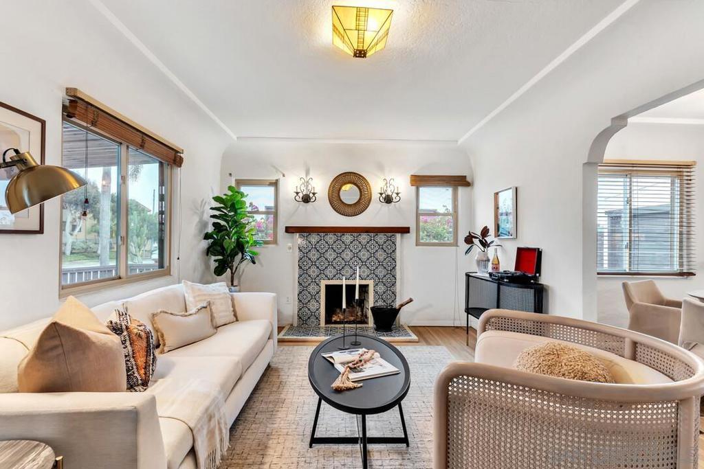 Stunning Spanish-Style Home in the Heart of North Park - Welcome to this beautifully maintained 2 bedroom, 1 bathroom Spanish-style home, perfectly situated in the highly sought-after North Park community. This single-story home blends timeless character with thoughtful modern upgrades—featuring original wood flooring, a remodeled kitchen with an adjacent dining area, an updated fireplace, and stylish exterior doors. Enjoy year-round comfort with central A/C and heat, plus peace of mind with a new tankless water heater (2024), French drains, and new turf installed in 2024. Step outside to relax on the cozy front porch or entertain in the private backyard, complete with a freshly built patio and pergola—perfect for gatherings or quiet mornings. Additional highlights include a one-car detached garage with laundry, gated off-street parking, and a fenced front yard ideal for pets or play. Just a short walk to 30th Street, Adams Avenue, and all of North Park’s popular shops, bars, and restaurants. With quick access to the 805 freeway, this location offers both convenience and lifestyle. Don’t miss this rare opportunity to own a character-filled home in one of San Diego’s most vibrant neighborhoods!