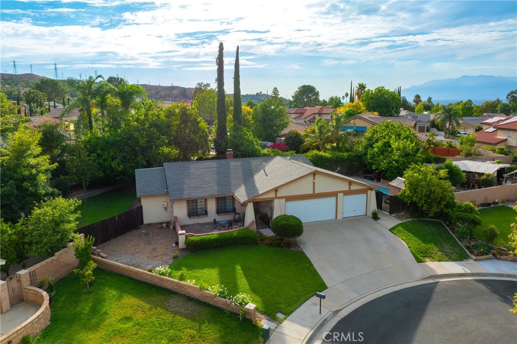 This south end Loma Linda pool home is beautiful. It has great curb appeal, located in a Cul de sac with mountain views and paid off solar with 18 panels. There are 4 bedrooms and 2 bathrooms on this sprawling 10,000 sqft lot. The upgraded kitchen has an open concept overlooking the living room with a fireplace & the open dining room. The kitchen has a gorgeous island. The countertops are all quartz and there are newer appliances. There is large tile flooring as well. The rest of the house has laminate wood flooring. All the bedrooms are nicely sized rooms. The bathrooms have some newer upgrades and show well. The interior was painted recently as well as the exterior. There is a gated pool and spa, with a working spa heater. Along with a large cement patio & park like lawn area. This home has a 2-car garage and the single side was converted to the 4th permitted bedroom. The house has block wall fencing throughout the majority of the backyard. Central AC & heat, along with a whole house fan. Upgraded 200 Amp electric panel. Front & back rain gutters. There is also room for an RV or trailer access, based on future designs of the south east side of the property.