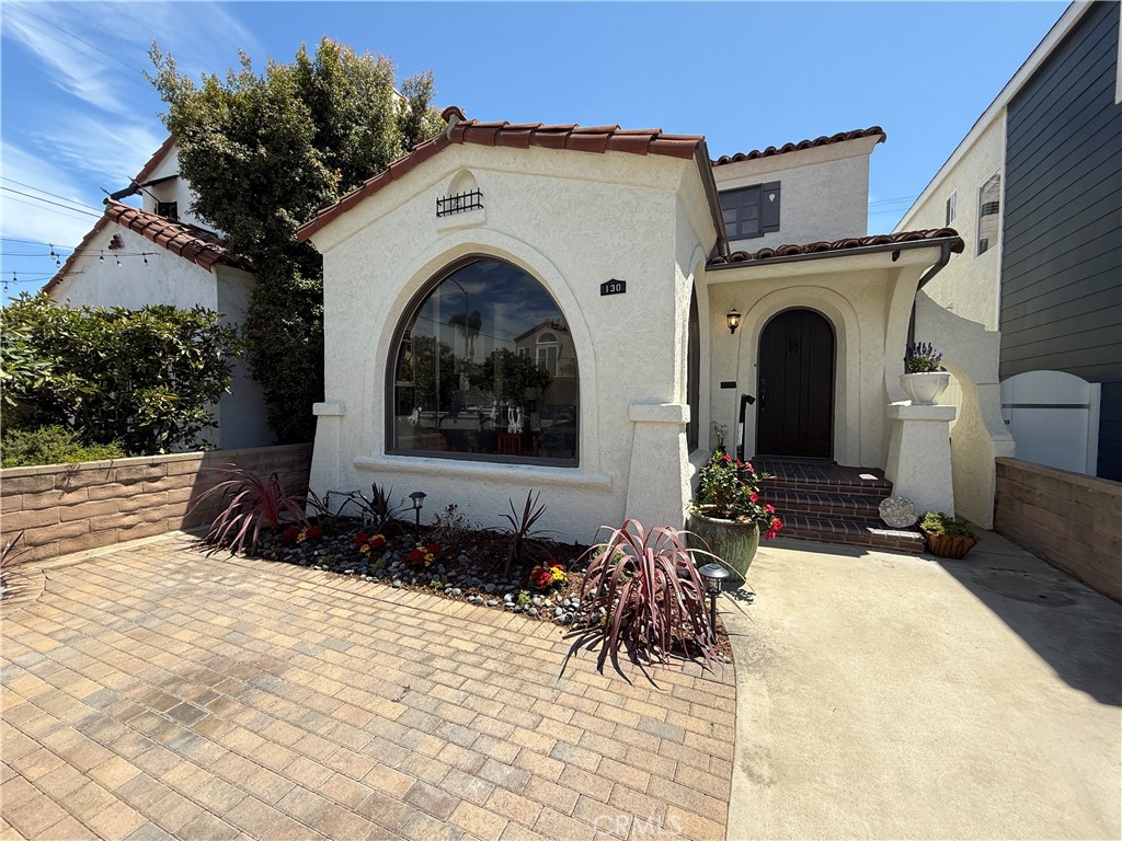 Beautiful vintage Spanish home with classic charm and modern updates.
Step inside and be captivated by the warmth of this home, where original details meet contemporary comforts. The refinished hardwood floors, beamed ceilings, and art nooks are a nod to its vintage character, while large arched picture windows flood the living spaces with natural light. The spacious dining room is perfect for hosting, and the sunny breakfast room off the kitchen is an ideal spot for your morning coffee. The kitchen has been thoughtfully refreshed with quartz countertops, a gold commercial faucet, and stainless steel appliances including a dishwasher, stove, and refrigerator. You'll also find a large laundry area and charming nooks throughout that only a vintage home can offer. Upstairs, a formal entry leads you to three bedrooms. The main bedroom features an attached sunroom, a versatile space perfect for a cozy reading nook or a home office.
Outside, a private patio yard provides a wonderful space to relax and enjoy the ocean breeze. Set up your umbrella and a comfortable seating area to soak up the sun. Located just a short walk or bike ride from Bayshore, 2nd Street, and the Long Beach Yacht Club, this home offers the quintessential beach lifestyle. Stroll to Ocean Boulevard to enjoy the Pacific or take a ride down the bike path to the pier. This home is move-in ready. Don't miss your chance to make this beauty yours.