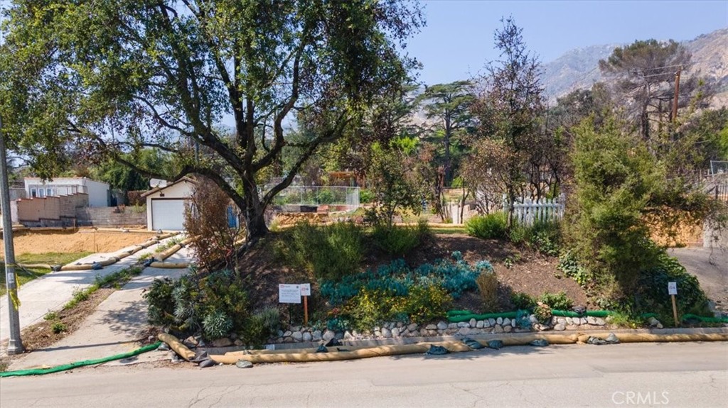 East of Lake Avenue on a desirable street in the neighborhood of Altadena, lays the land of 999 Wapello Street. This lot presents an excellent opportunity to construct a new home on a parcel of 6,926 SF. Public records indicate the lost home was 1,268 square feet with 3 beds, 2 baths, plus a two car, detached garage. The lot is situated on the north side of the street with a beautiful oak tree, which survived the fires, providing shade in the front. The gentle slope in the front set the home on a flat pad with a slight elevation from the street to take advantage of views to the valley below and the San Gabriel Mountains behind the home. This home was destroyed in the Eaton Fire, and the property is being sold as land only. Phases I and II of the property cleanup and debris removal are complete.