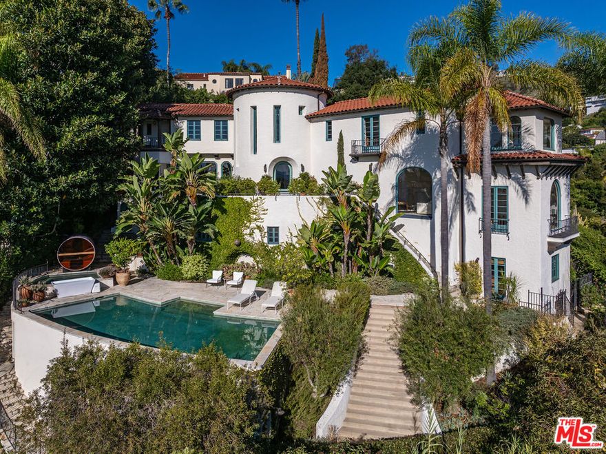 Perched above the Sunset Strip, this impeccably restored 1926 Spanish Revival by architect Robert Finkelhor commands cinematic, uninterrupted views from downtown to the Pacific. A timeless Spanish facade opens to warm, modern interiors defined by hand-textured plaster, sunlit rooms, and beautifully preserved architectural details. Gracious living and dining spaces flow to multiple terraces that frame the sweeping panoramas and seamlessly extend living outdoors. The residence offers six bedrooms and five-and-a-half baths, including a serene primary suite with sitting room and marble bath. A separate flex outbuilding serves as an ideal studio, gym, office, or creative workspace. Wellness amenities include a sauna and cold plunge, while a saltwater pool and spa sit against the home's dramatic city-to-ocean backdrop, surrounded by mature landscaping and private outdoor areas. A serene, private retreat with an effortless, refined calm just moments from the Chateau Marmont, Sunset Tower, and the energy of the Sunset Strip.