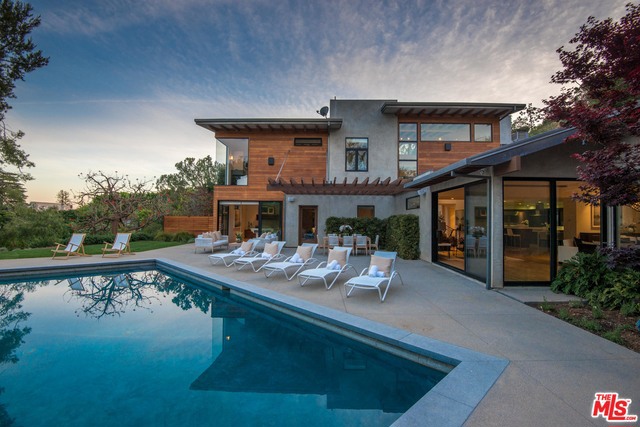 Down a long and private drive sits an architectural gem in the highly coveted Palisades Riviera. This meticulously designed five bedroom, five bathroom house features jetliner views and sits on nearly 1 acre of lushly landscaped grounds creating your own private oasis. The large chef's kitchen features top-of-the-line appliances, Caesarstone countertops and the kitchen adjoins a breakfast area, formal dining room and family room, all of which open to the pool and outdoor entertaining area. House is equipped with OLED TV's and wine fridge. The luxurious master suite with large sitting room boasts stunning canyon and city views, his and her closets steam shower and over-sized tub. Irregularly shaped lot. Fully remodeled in 2011.