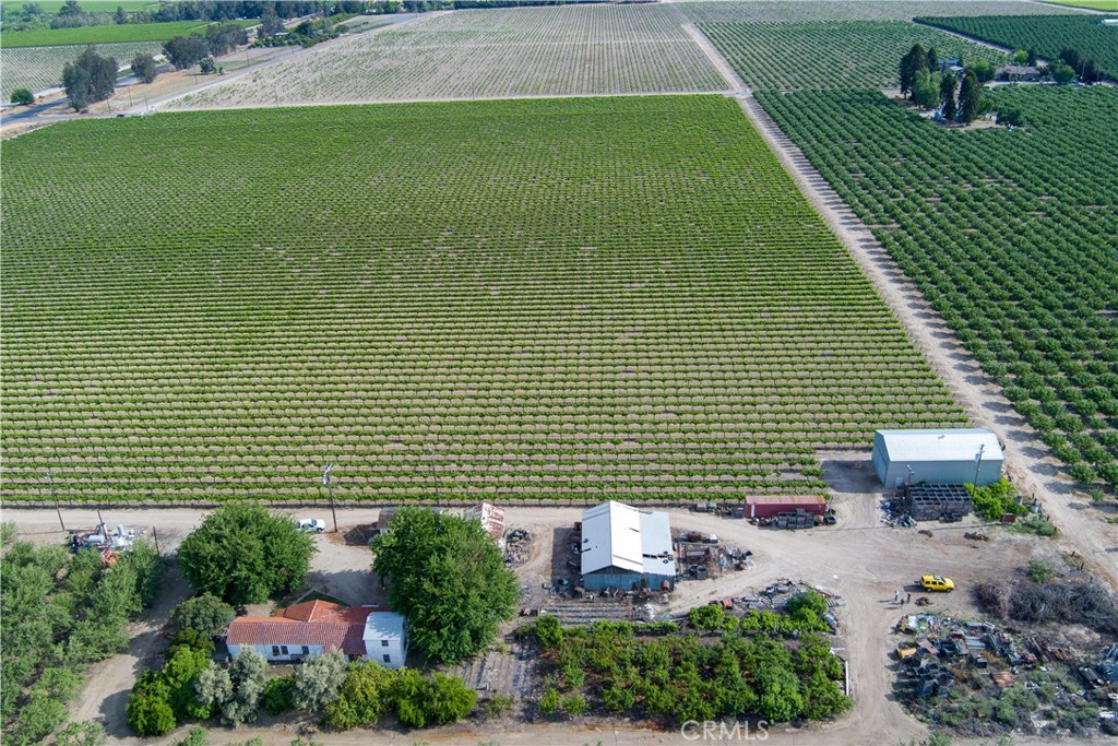 HUGE PRICE IMPROVEMENT!!!
Located at Ave 6 & Highway 145 in rural Madera, the property offers 74.48-acre agricultural investment opportunity. Comprising five parcels (APNs: 040-141-001, -002, -003, -004, and 040-141-027), the property combines 37± acres of almond orchard, 35± acres of raisin grape vineyard, and 2.48± acres of ancillary land featuring a residence and farm buildings. Situated at the high-visibility intersection of Avenue 6 and Highway 145, just 7.5 miles south of Madera, the site benefits from excellent access and exposure in a stable agricultural area.
The property is zoned ARE-20 (Agricultural, Rural, Exclusive – 20-Acre District), allowing a wide range of agricultural uses while preserving its commercial farming utility. Surrounding land uses include similar agricultural operations and rural residences, reinforcing the property’s long-term suitability for crop production.
The land features generally level topography and high-quality Class III soils with an overall Storie Index of 81.
The Property benefits from reliable water from both surface and groundwater sources. It is served by the Madera Irrigation District and includes one on-site pump and well. Significantly, the property falls within the Madera Irrigation District GSA, which currently imposes no groundwater pumping restrictions. This dual-source irrigation enhances water security and operational resilience.
In addition to its productive orchards and vineyard, the property includes vital supporting infrastructure such as a primary residence, detached garage, older apartment unit, equipment shed, and shop. These facilities support daily agricultural operations and provide potential housing for on-site management or labor. Fuel storage tanks are present on-site, but no hazardous materials were observed during inspection.
With strong soils, robust irrigation access, and established infrastructure, the property is ideally suited for continued vineyard use and the redevelopment of the almond orchard into alternative permanent crops like pistachios or citrus. The site’s prime location, agricultural zoning, and secure water rights make it a strong candidate for long-term investment or owner-operator use.