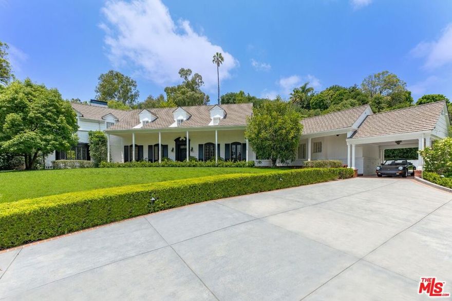 A stunning Beverly Hills estate on approx 1 acre lot, completely rebuilt from the ground up, taking inspiration from the owners original 1930s C. S. Arganbright home. Arrive to a large motor court that is set beside a large grassy front lawn. Original features including the home's front door, numerous bricks, and millwork details were used in the new build to retain the historic charm, while the latest and greatest amenities were added for modern living. Beautiful details and finishes throughout the home include wide-plank hardwood floors, a double-height entry hall with a sweeping curved staircase, high ceilings, and gorgeous woodwork. The rooms are spacious and light-filled and create a warm and welcoming atmosphere. Primary suite offers fireplace, walk-in closet, and private balcony overlooking the backyard. French door on main level open to a expansive backyard with spacious patio with fire pit, multiple seating areas, flat grassy lawn, and unique curved pool with cabana. Set in prime Beverly Hills, this rare estate seamlessly blends traditional style with the ultimate modern comforts and is perfect for indoor/outdoor living and entertaining.
