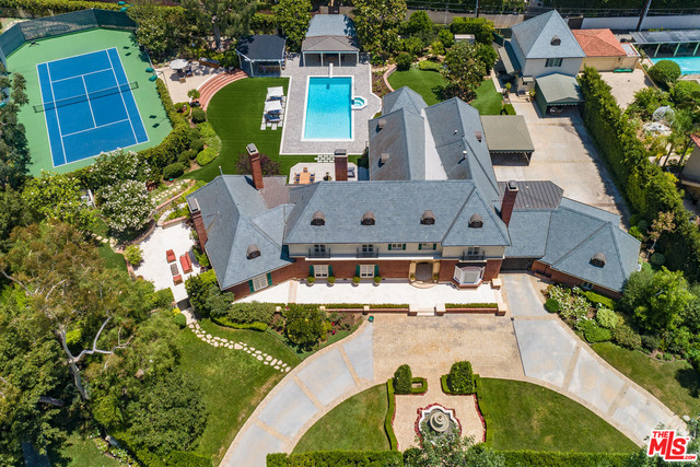 Legendary Beverly Hills Estate on 53,000+sqft lot. Sited on one of the largest lots in the flats of Beverly Hills. This trophy compound offers a beautiful lit tennis court, verdant grounds, large main house, pool house and guest house. A gated circular motor court sets the tone and sense of arrival. Built in 1935, the Georgian Traditional has a rich and illustrious pedigree. Encompassing over 7,600sqft the main house features high ceilings and classic proportions. Elegant entry hall with sweeping staircase, grand living room, massive paneled den that converts to a screening room, library with fireplace and large formal dining room. Gourmet kitchen with circular breakfast room. Spacious master suite features dual baths and walk in closets. Total of 7 bedrooms and 8 baths. Exceptional grounds include vast side motor court area with covered parking for 5 cars. One of kind. Shown only to prequalified Buyers.